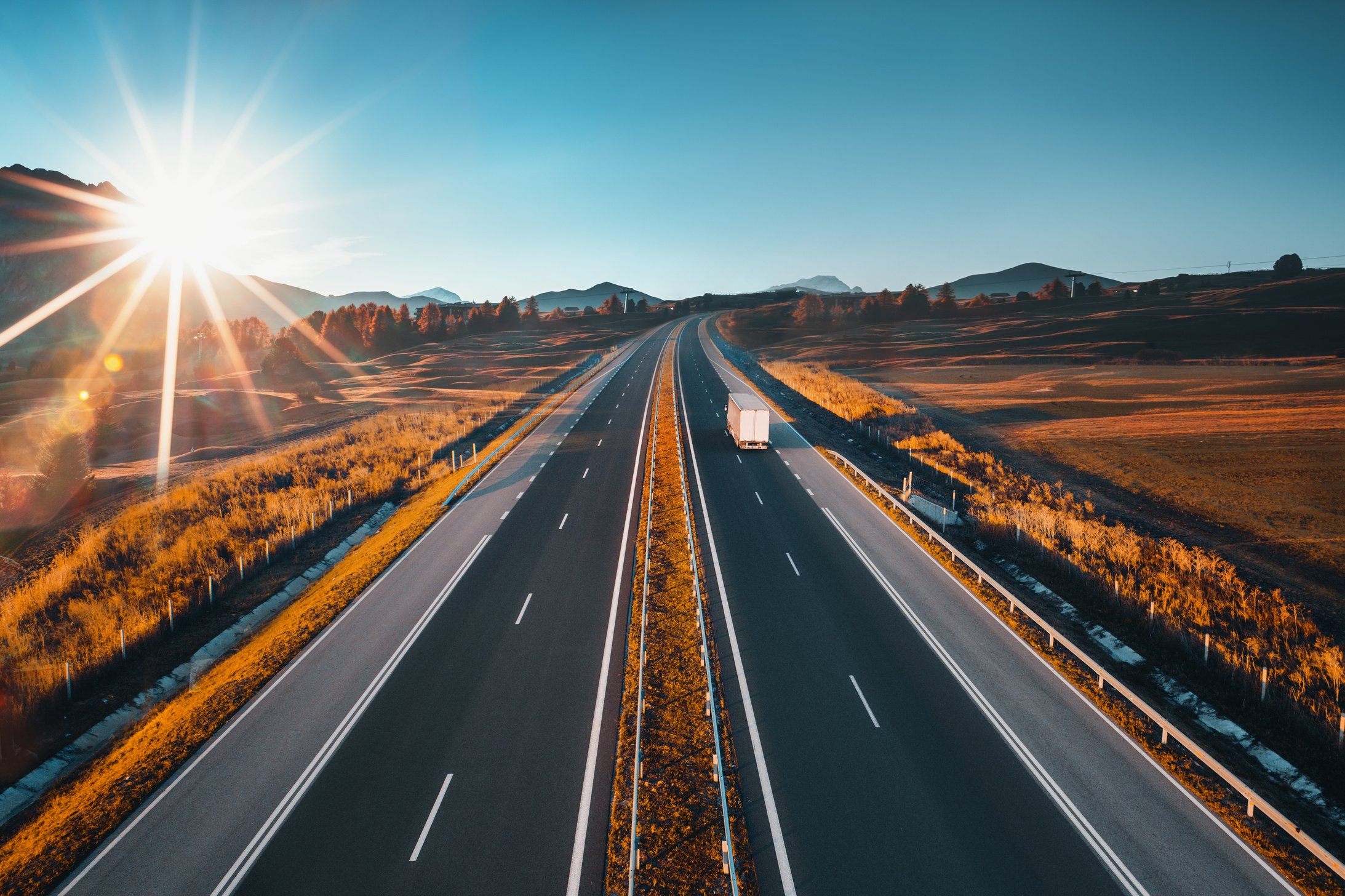 Driving on open road at beautiful sunny day. Aerial view of highway.